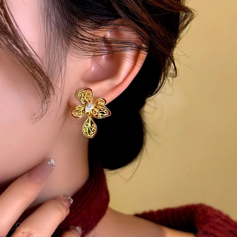 Model showcasing the dangle and style of the 14K Gold-Plated Zircon Enamel Filigree Flower Earrings