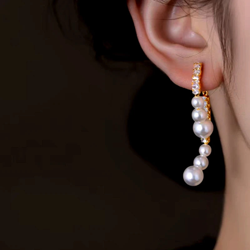 Angled view of the 14K Gold-Plated Zircon Face-Slimming Pearl Earrings