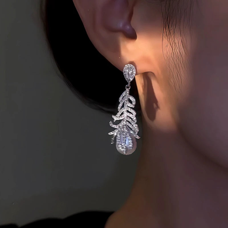 Close-up detail of the sparkling zircons and plating on the Feather Pearl Earrings