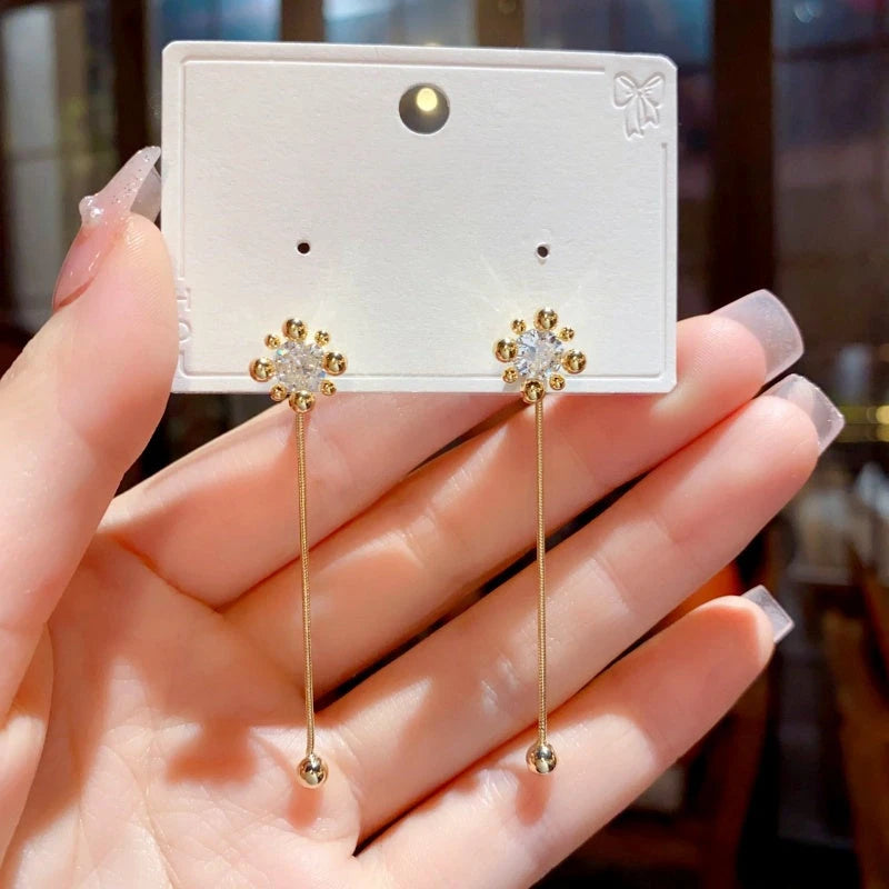 Close-up detail of the sparkling zircons and plating on the Convertible Firework Earrings