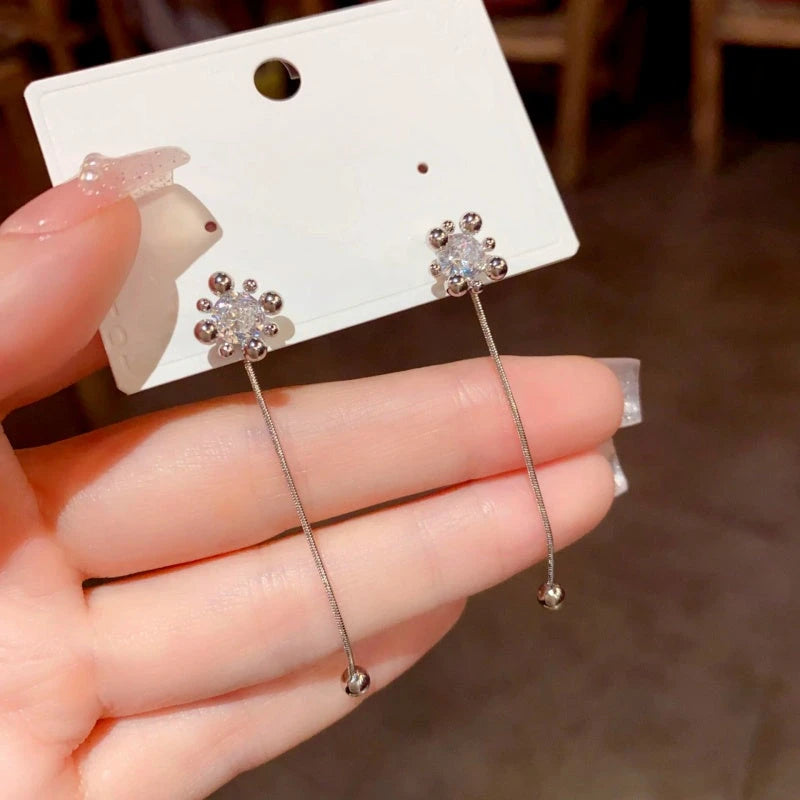 Angled view of the 14K Gold-Plated Zircon Fireworks Tassel Two-Wear Earrings