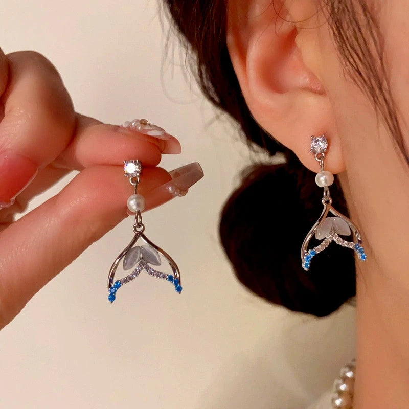 Model showcasing the dangle and style of the 14K Gold-Plated Zircon Fishtail Pearl Earrings