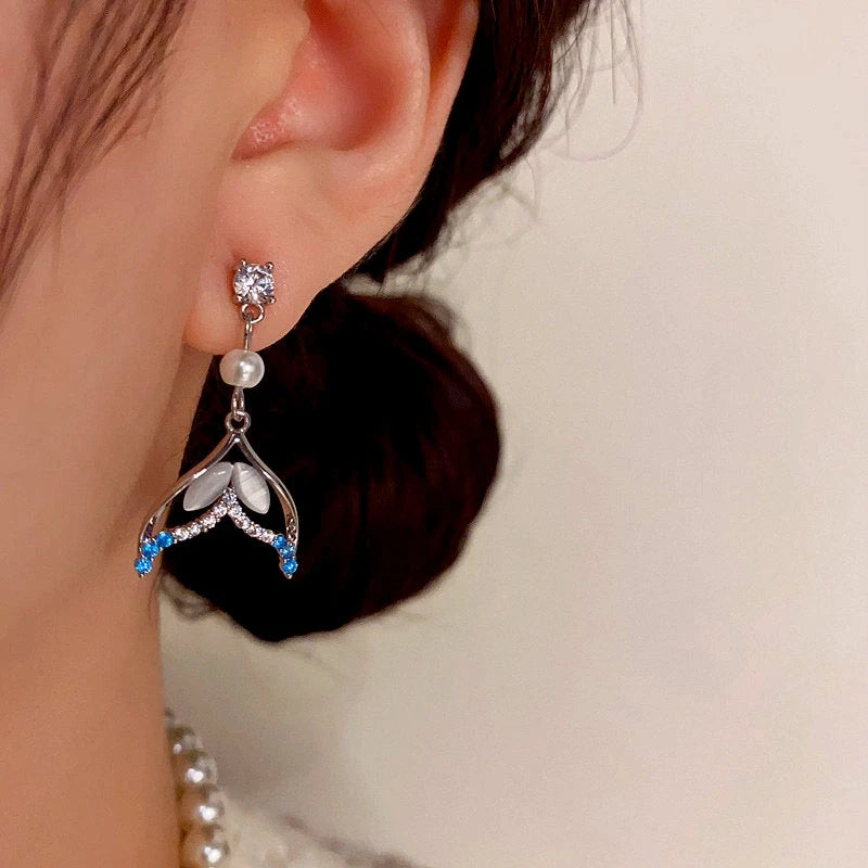 Angled view of the 14K Gold-Plated Zircon Fishtail Pearl Earrings