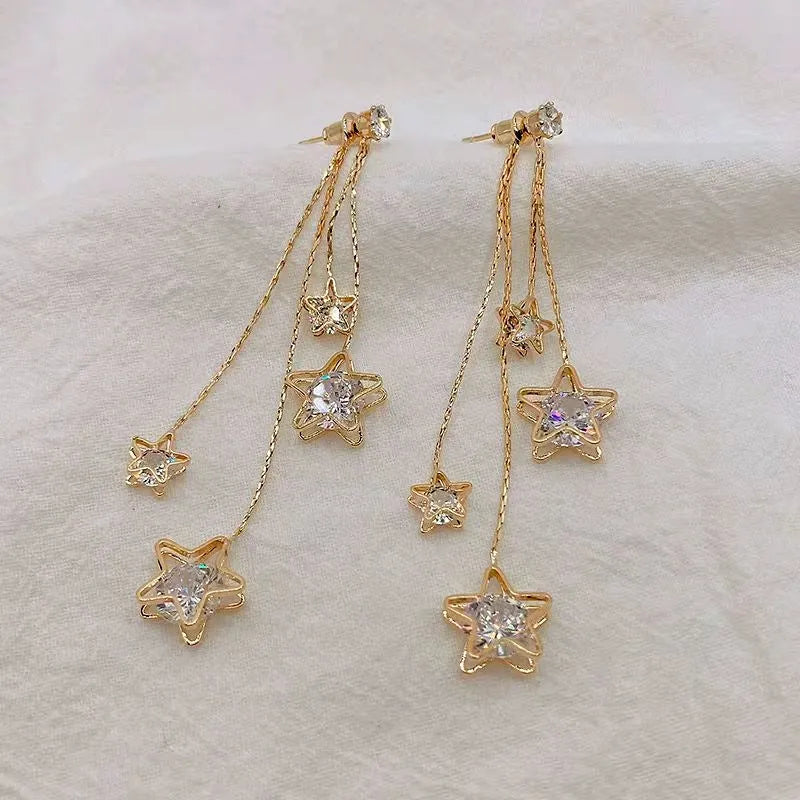 Close-up detail of the sparkling zircons and plating on the Star Tassel Earrings