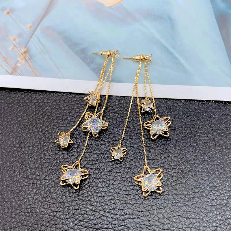 Angled view of the 14K Gold-Plated Zircon Five-Pointed Star Tassel Earrings