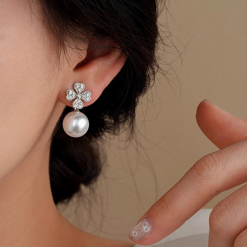 Model showcasing the dangle and style of the 14K Gold-Plated Zircon Flower Bead Earrings