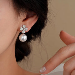 Model showcasing the dangle and style of the 14K Gold-Plated Zircon Flower Bead Earrings