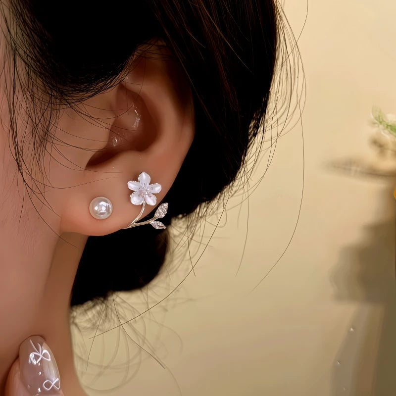 Model showcasing the dangle and style of the 14K Gold-Plated Zircon Flower Bead Jacket Earrings