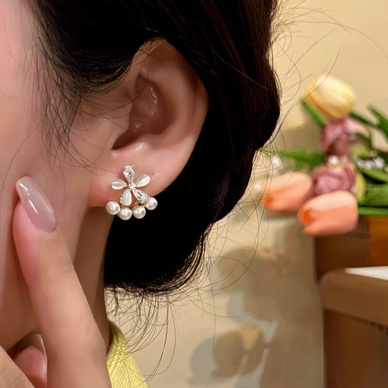 Close-up detail of the sparkling zircons and plating on the Golden Flower Ear Jackets