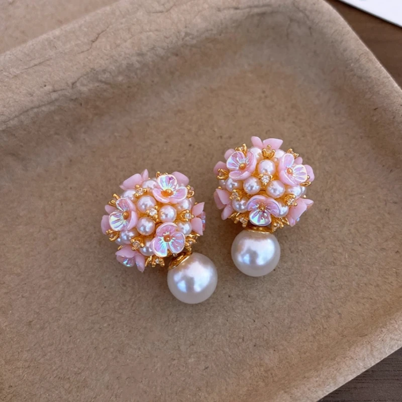 Angled view of the 14K Gold-Plated Zircon Flower Bead Jacket Earrings