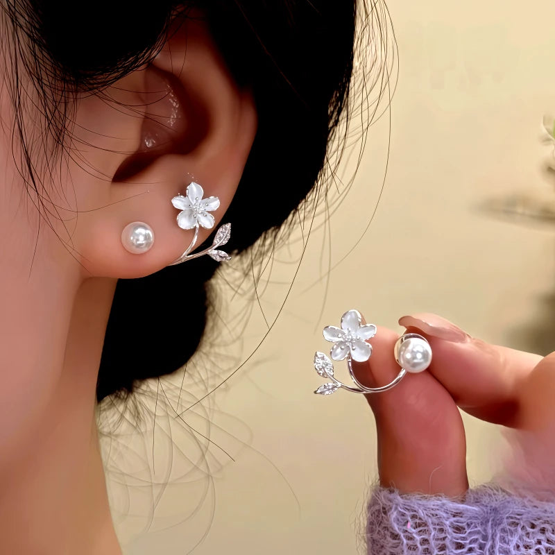 Angled view of the 14K Gold-Plated Zircon Flower Bead Jacket Earrings