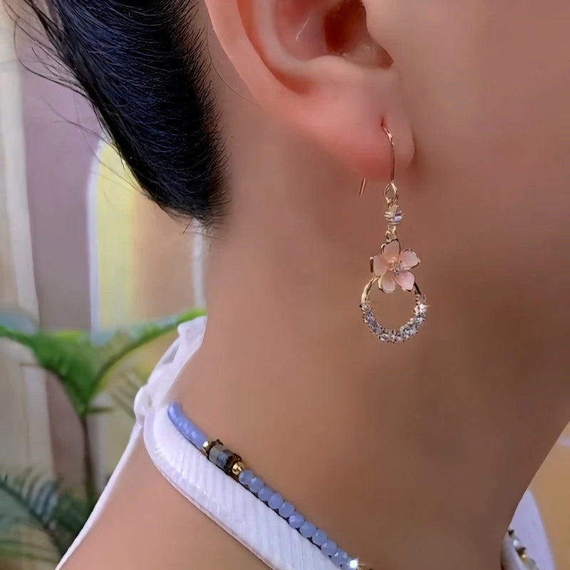 Model showcasing the dangle and style of the 14K Gold-Plated Zircon Flower Ear Hooks