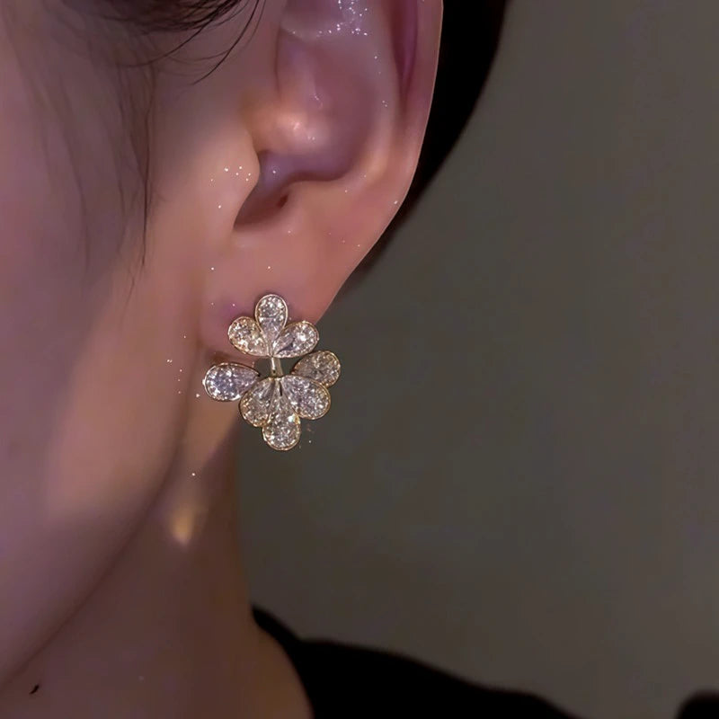 Model showcasing the dangle and style of the 14K Gold-Plated Zircon Flower Earrings