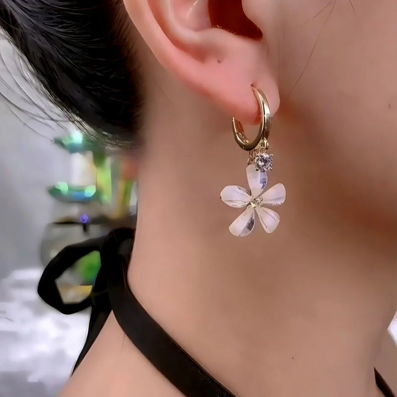 Model showcasing the dangle and style of the 14K Gold-Plated Zircon Flower Earrings