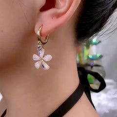 Close-up detail of the sparkling zircons and plating on the Sunburst Flower Earrings