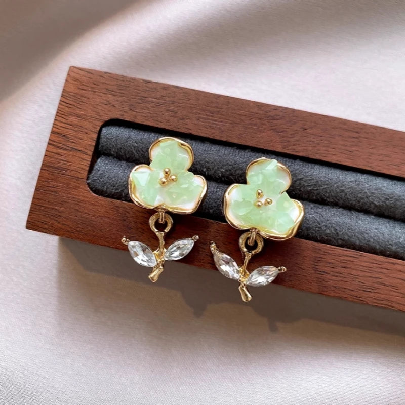 Close-up detail of the sparkling zircons and plating on the Green Flower Earrings