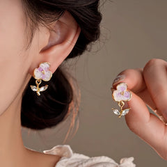 Model showcasing the dangle and style of the 14K Gold-Plated Zircon Flower Earrings