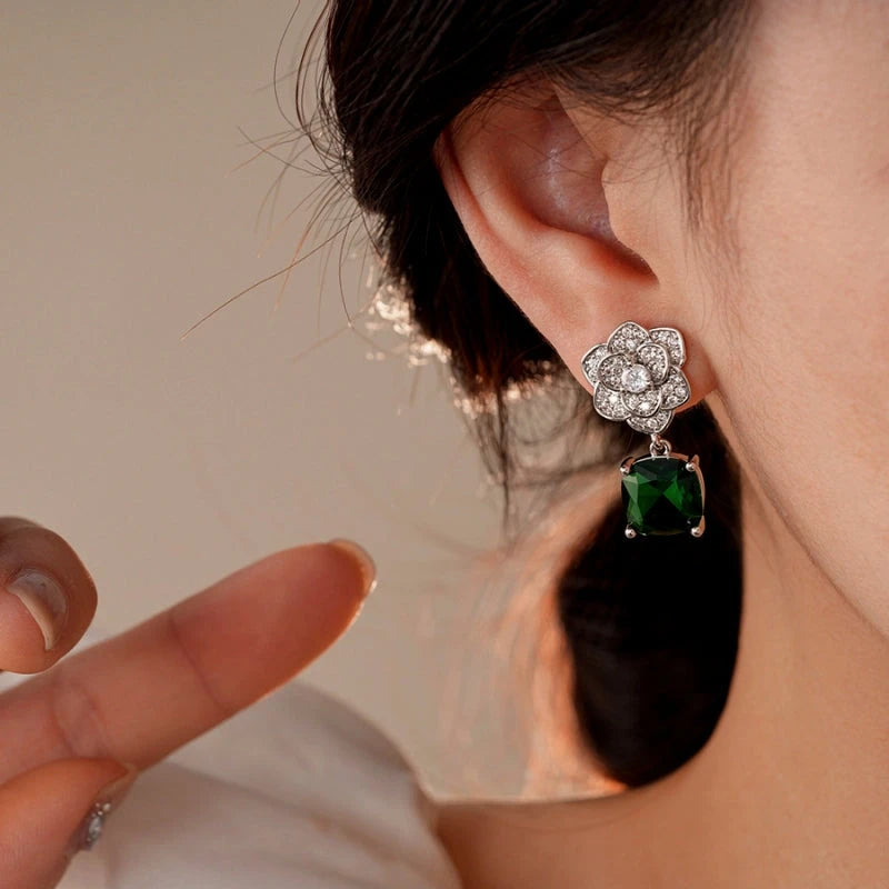 Model showcasing the dangle and style of the 14K Gold-Plated Zircon Flower Green Diamond Earrings
