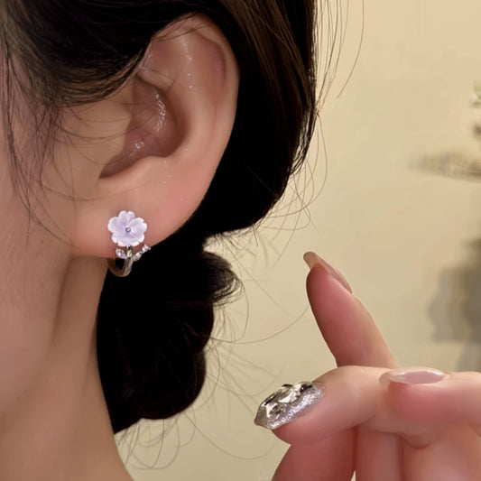 Model showcasing the dangle and style of the 14K Gold-Plated Zircon Flower Hoop Earrings