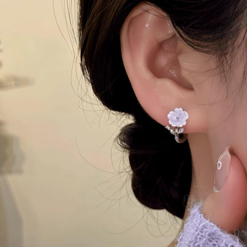 Close-up detail of the sparkling zircons and plating on the Dangling Flower Hoops