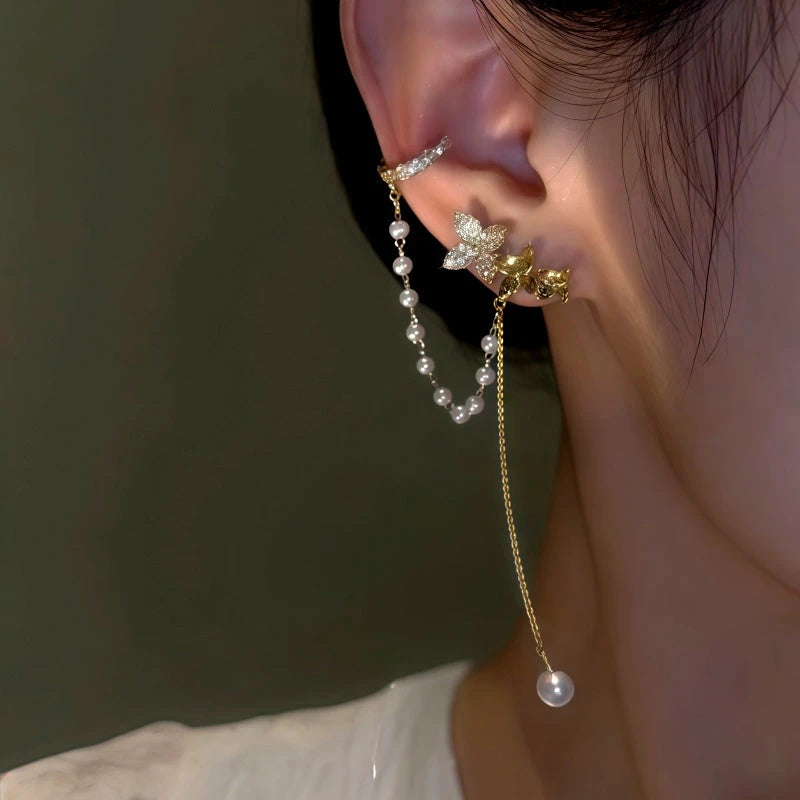 Model showcasing the dangle and style of the 14K Gold-Plated Zircon Flower Pearl Ear Cuffs (1 Pair)