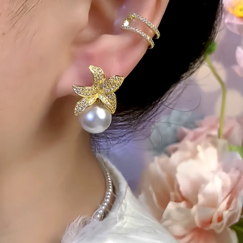 Model showcasing the dangle and style of the 14K Gold-Plated Zircon Flower Pearl Earrings