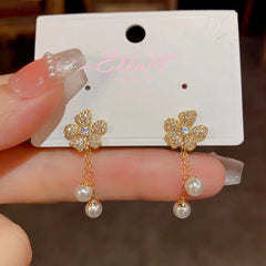 Angled view of the 14K Gold-Plated Zircon Flower Pearl Tassel Earrings