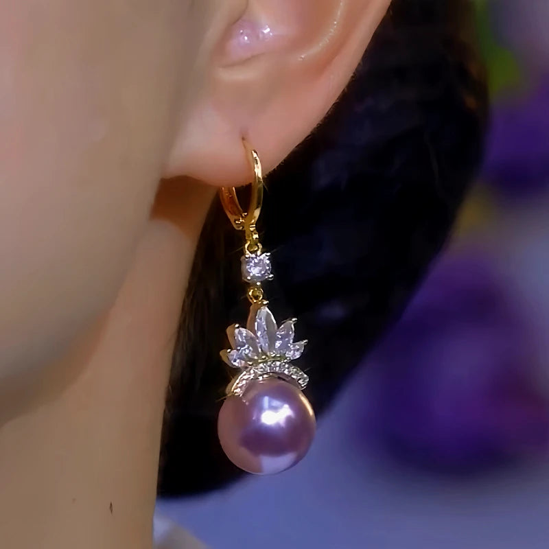 Model showcasing the dangle and style of the 14K Gold-Plated Zircon Flower Purple Pearl Earrings