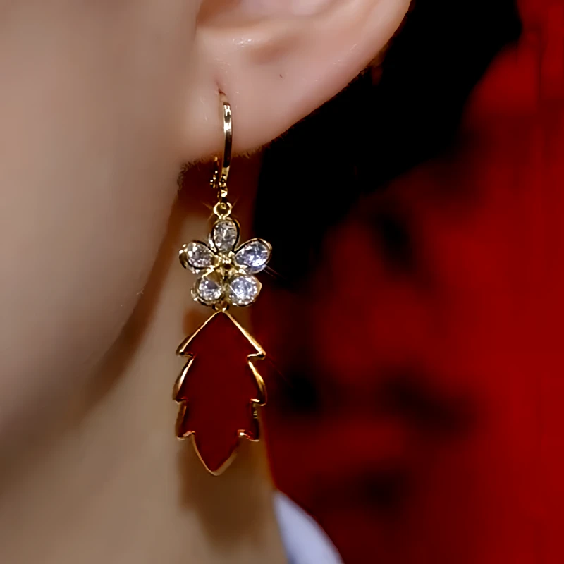 Model showcasing the dangle and style of the 14K Gold-Plated Zircon Flower Red Leaf Earrings