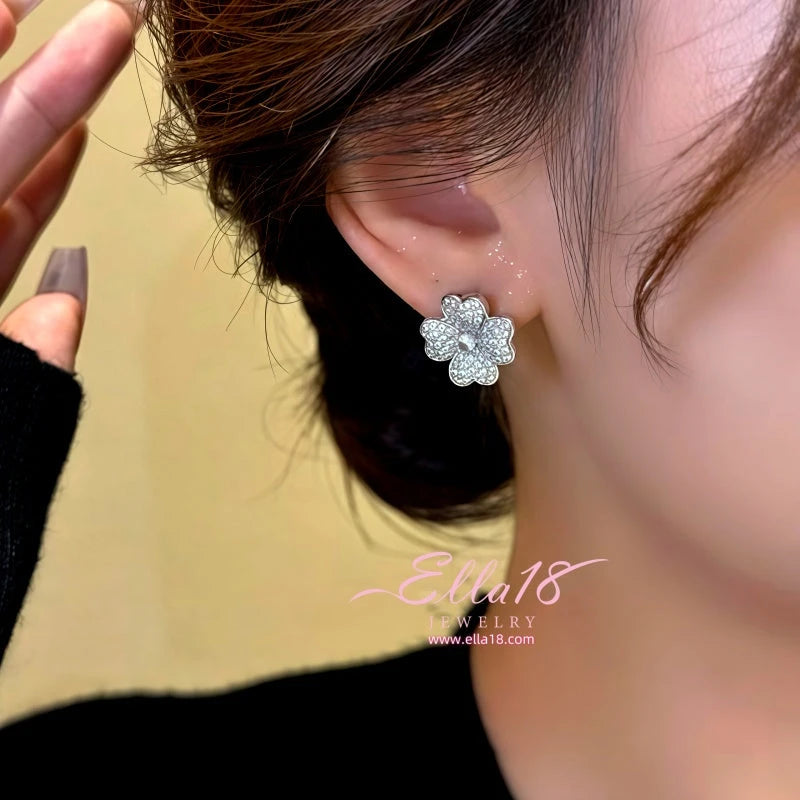 Model showcasing the dangle and style of the 14K Gold-Plated Zircon Flower Stud Earrings