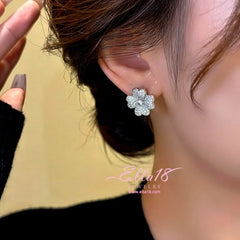 Model showcasing the dangle and style of the 14K Gold-Plated Zircon Flower Stud Earrings