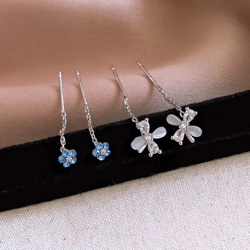 Model showcasing the dangle and style of the 14K Gold-Plated Zircon Flower Threader Earrings