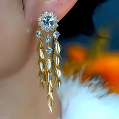 Model showcasing the dangle and style of the 14K Gold-Plated Zircon Flower Wheat Tassel Earrings