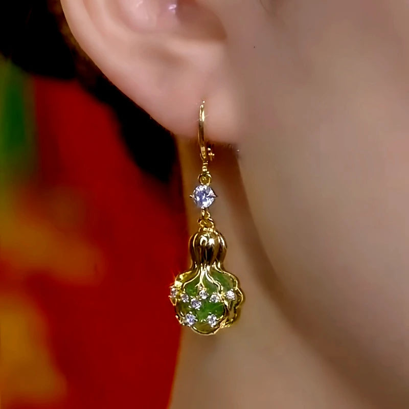 Model showcasing the dangle and style of the 14K Gold-Plated Zircon Fortune Earrings