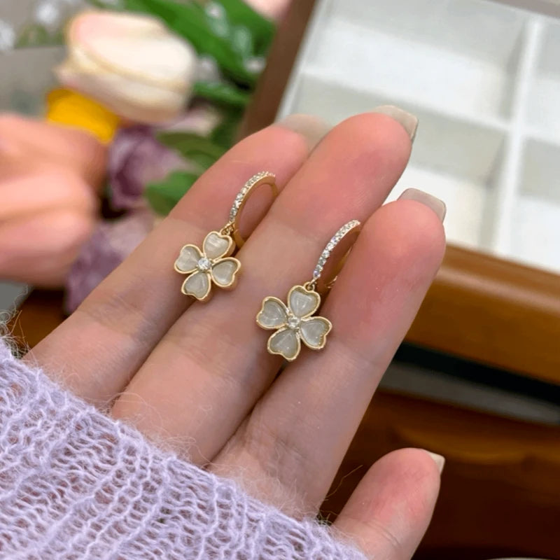 Angled view of the 14K Gold-Plated Zircon Four-Leaf Cat's Eye Stone Earrings
