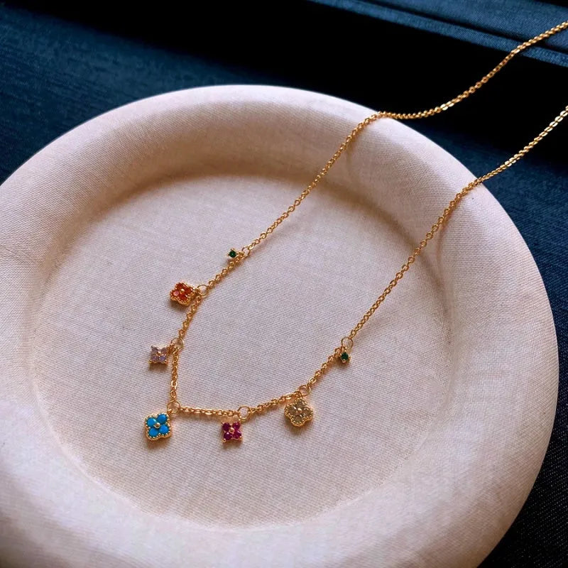 Detailed view of the 14K Gold-Plated Zircon Four-Leaf Clover Tassel Necklace chain and pendant