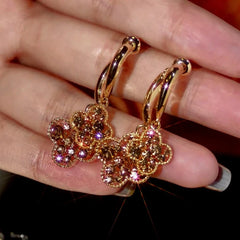 Angled view of the 14K Gold-Plated Zircon Four-Leaf Flower Earrings
