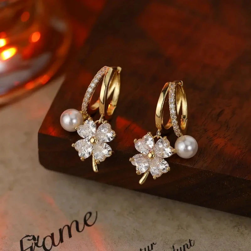 Angled view of the 14K Gold-Plated Zircon Four-Leaf Flower Pearl Earrings