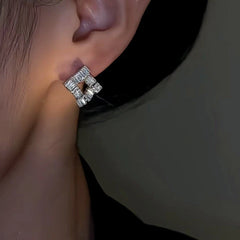 Close-up detail of the sparkling zircons and plating on the Square Stud Earrings