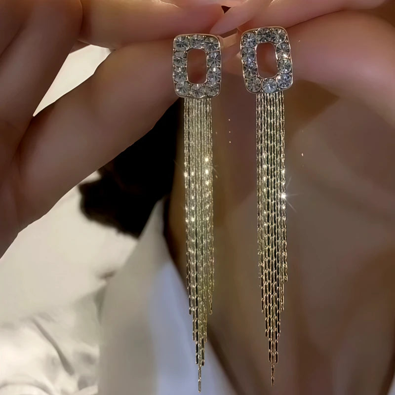 Model showcasing the dangle and style of the 14K Gold-Plated Zircon Geometric Tassel Earrings
