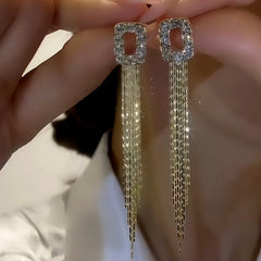 Model showcasing the dangle and style of the 14K Gold-Plated Zircon Geometric Tassel Earrings