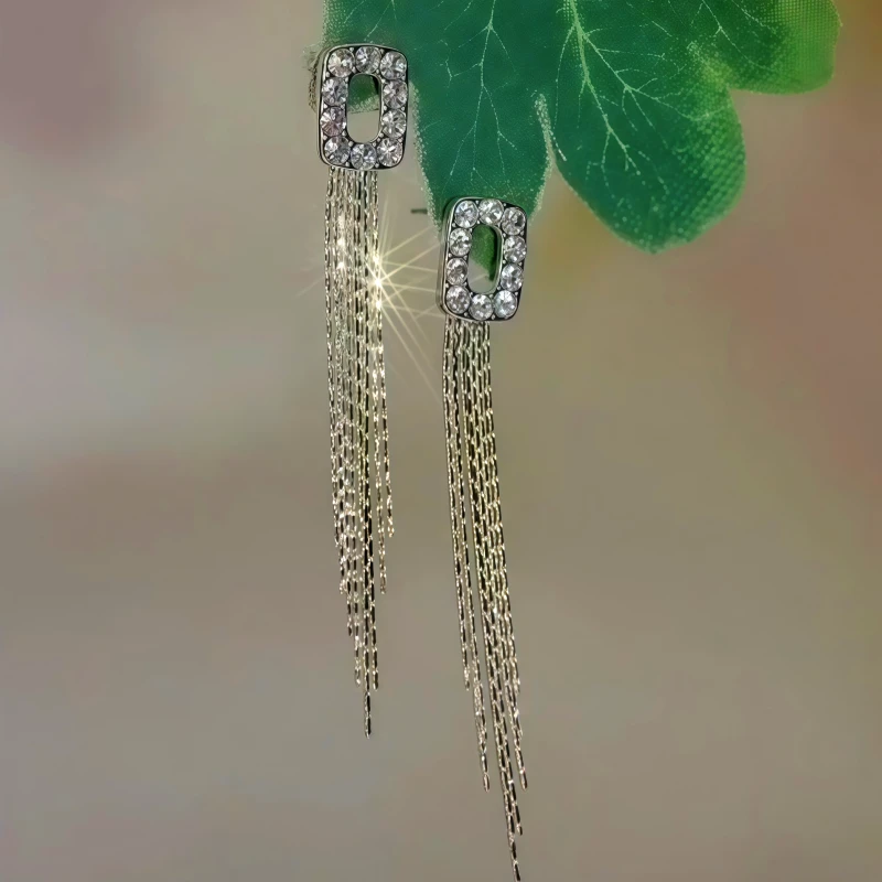 Angled view of the 14K Gold-Plated Zircon Geometric Tassel Earrings