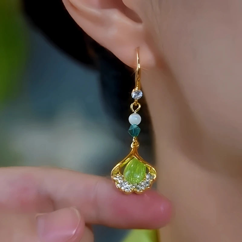 Model showcasing the dangle and style of the 14K Gold-Plated Zircon Ginkgo Leaf Ear Hooks