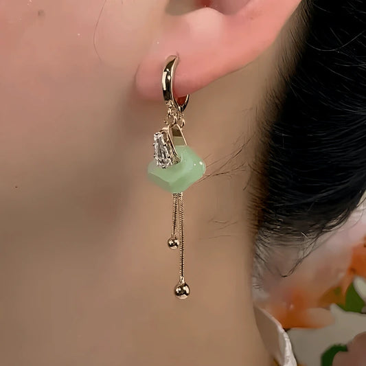 Model showcasing the dangle and style of the 14K Gold-Plated Zircon Gourd Earrings