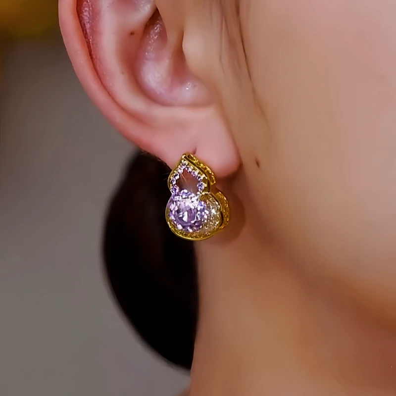 Model showcasing the dangle and style of the 14K Gold-Plated Zircon Gourd Good Luck Earrings