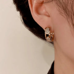 Close-up detail of the sparkling zircons and plating on the Gourd Hoop Earrings