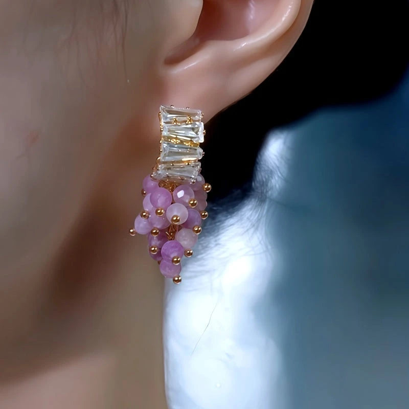 Model showcasing the dangle and style of the 14K Gold-Plated Zircon Grapes Tassel Earrings