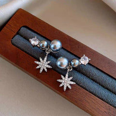Model showcasing the dangle and style of the 14K Gold-Plated Zircon Gray Pearl Star Earrings