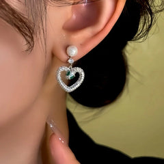 Close-up detail of the sparkling zircons and plating on the Snake Heart Earrings