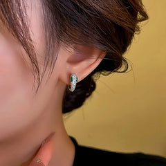 Close-up detail of the sparkling zircons and plating on the Silver Snake Hoops